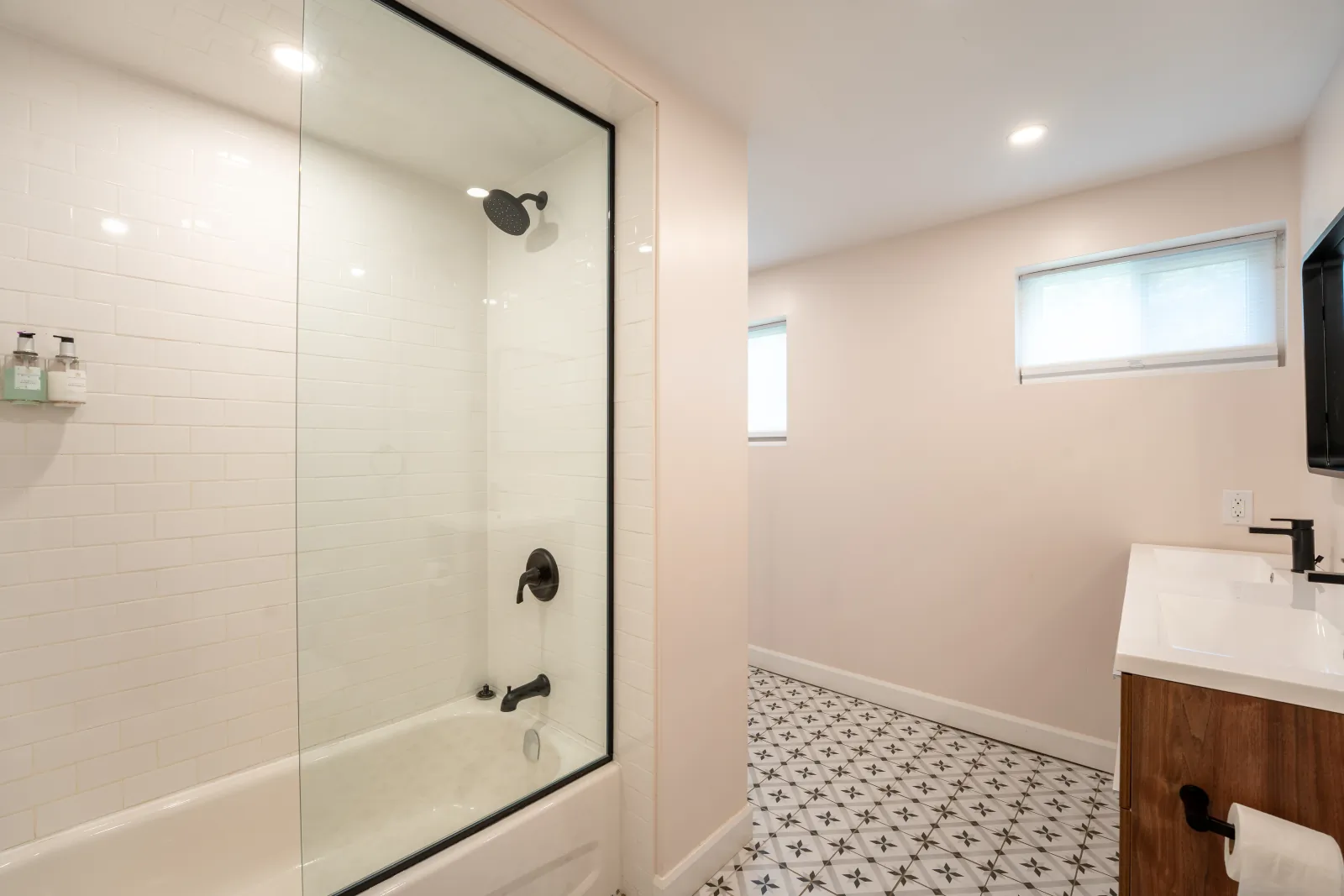 The 44L gallery: subway-tiled tub shower with a glass screen