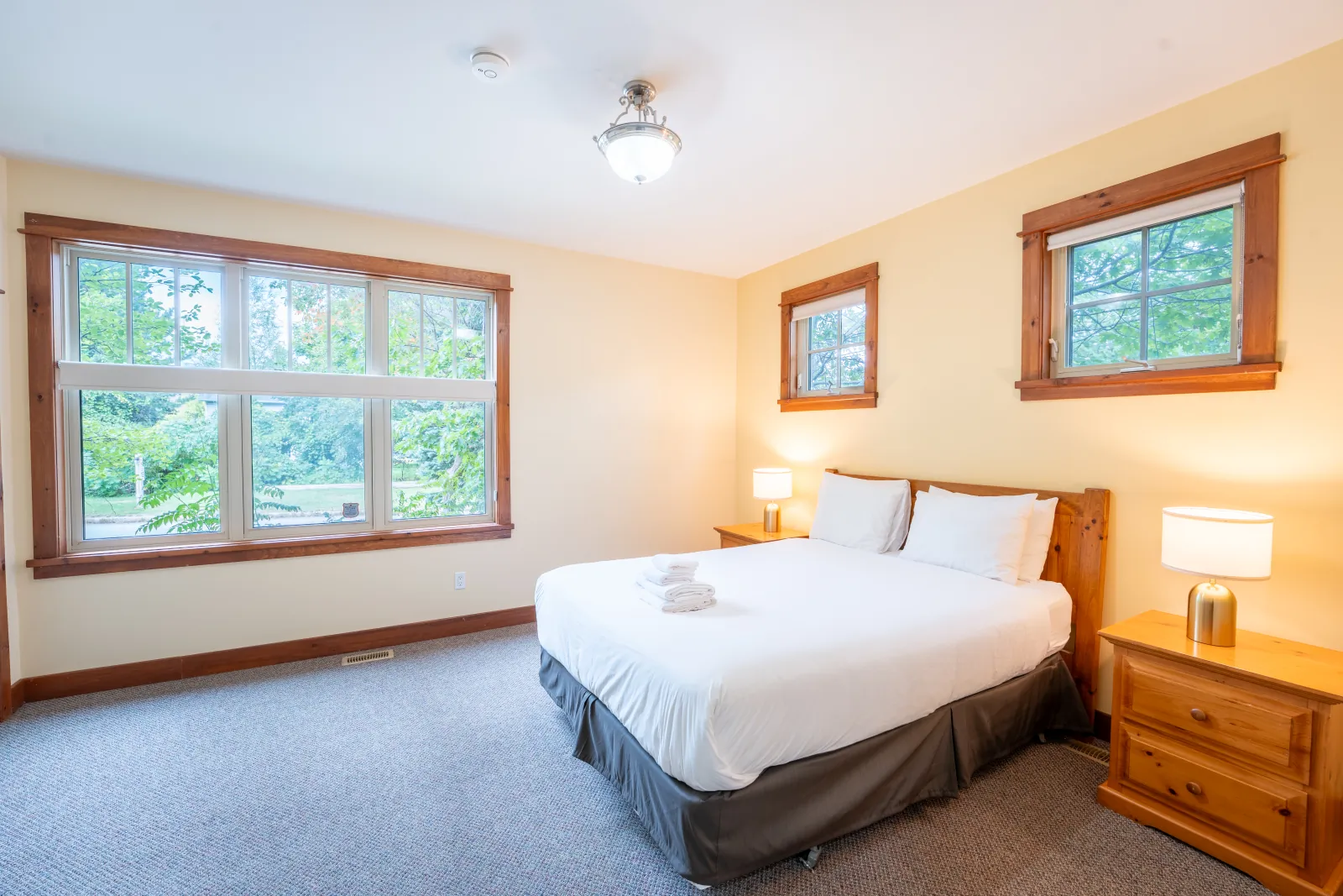 The Aurora gallery: king bedroom with corner windows and pine trim