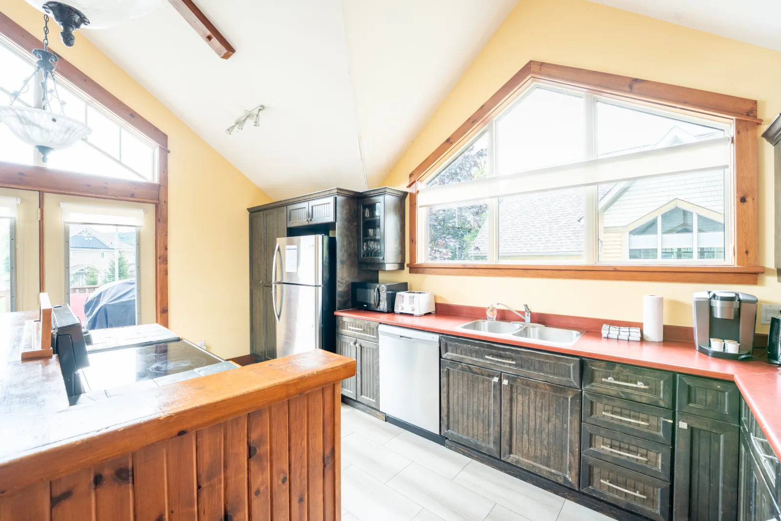 The Aurora gallery: kitchen with red counters and stainless appliances from the island