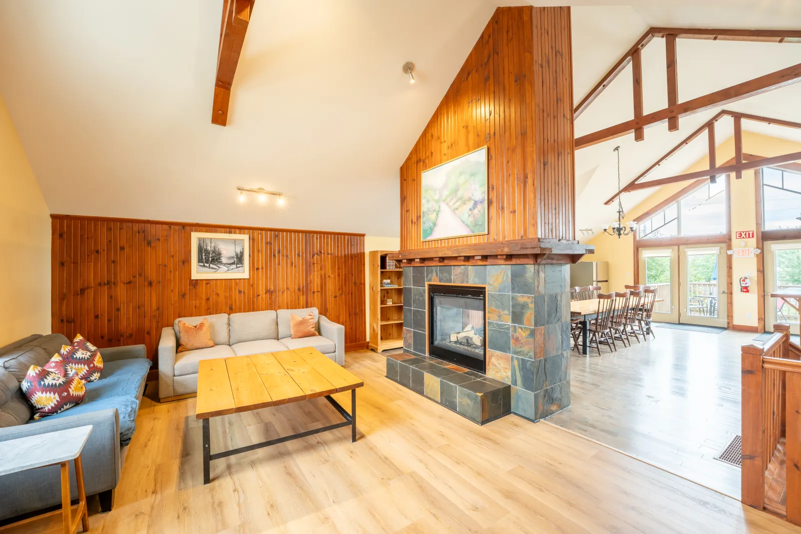 The Aurora gallery: living room with the stone fireplace and dining area beyond