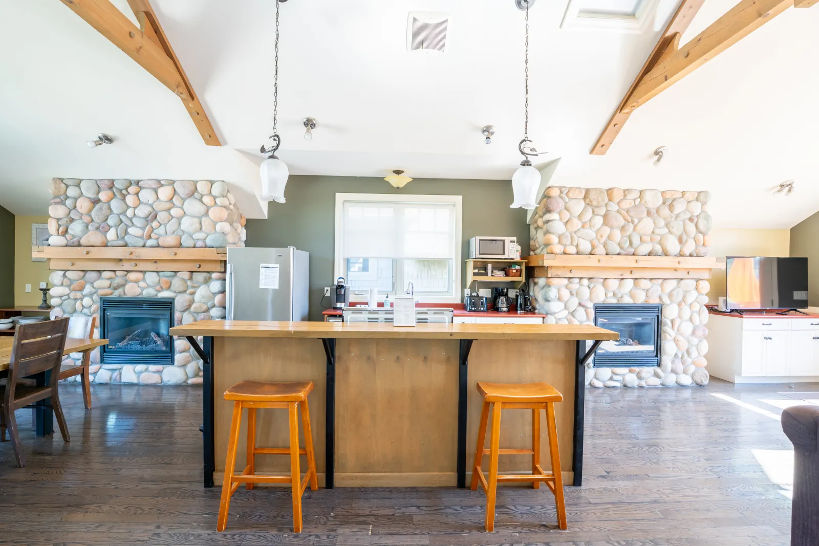 The Corona gallery: kitchen island between two stone fireplaces