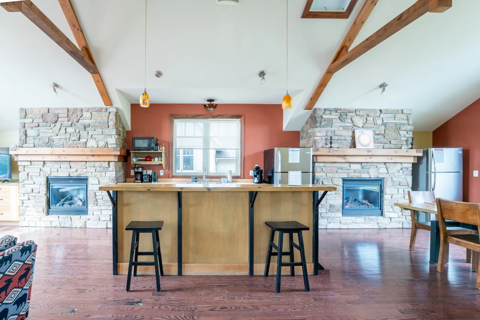 The Luna gallery: kitchen island between two stone fireplaces