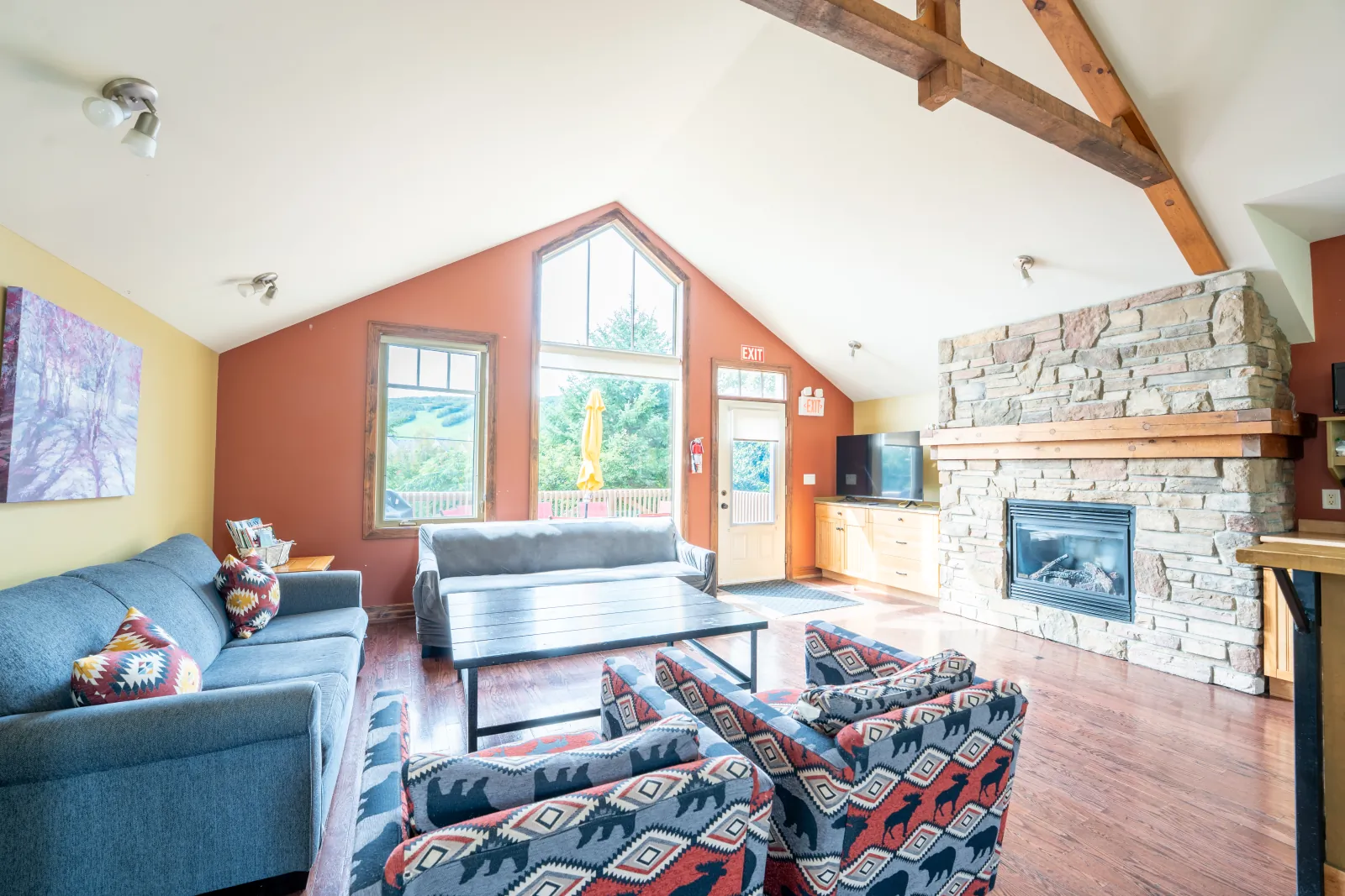 The Luna gallery: sofas beside the stone fireplace and red accent wall