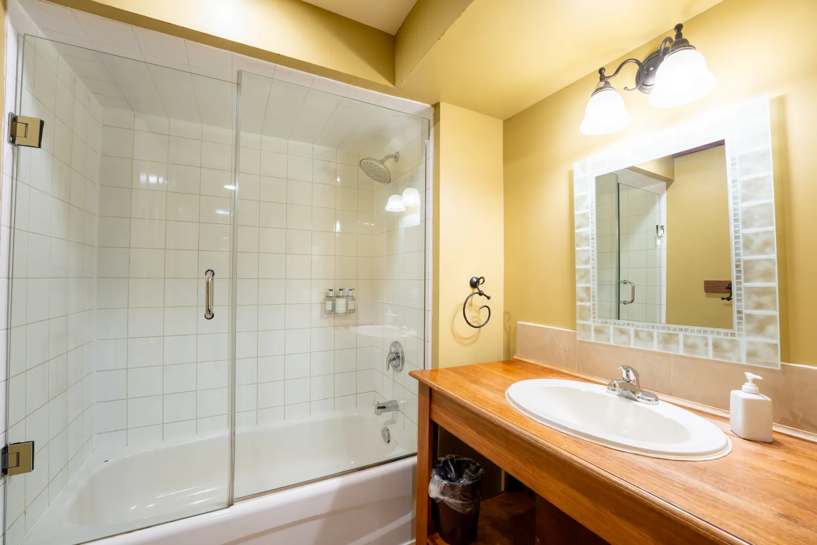 The Omega gallery: glass-screened tub shower and vanity