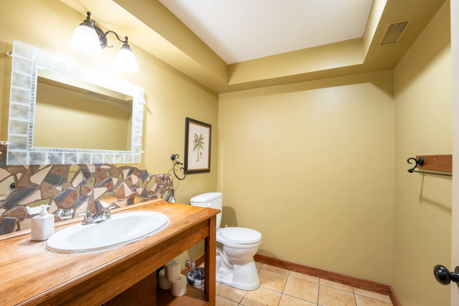The Omega gallery: bathroom with a stone-framed mirror over the vanity