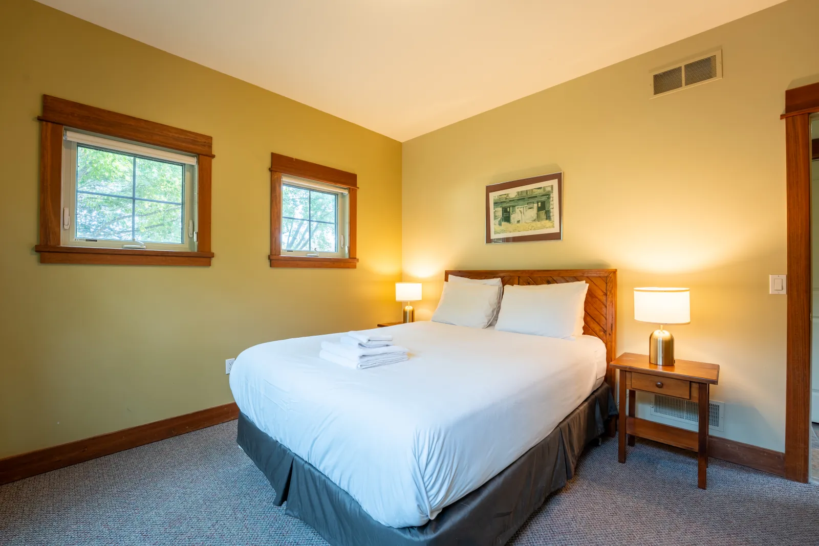 The Omega gallery: king bed with a night table and wall art