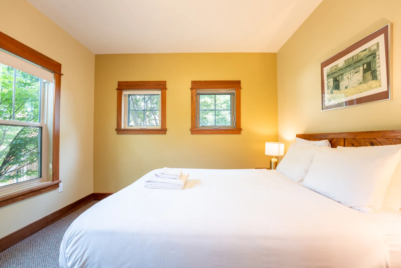 The Omega gallery: king bedroom with three windows and pine trim