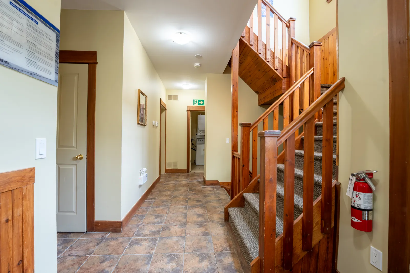 The Omega gallery: entry hall with the wooden staircase and tiled floor