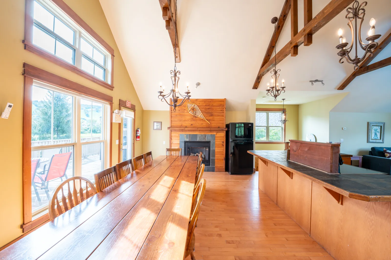 The Omega gallery: great room from the kitchen: dining table and fireplace