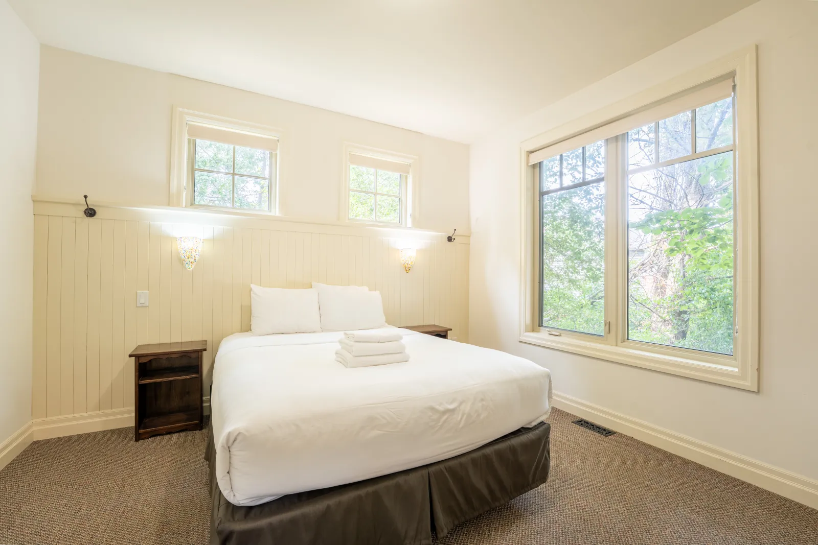 The Prima gallery: queen bed beside tall windows