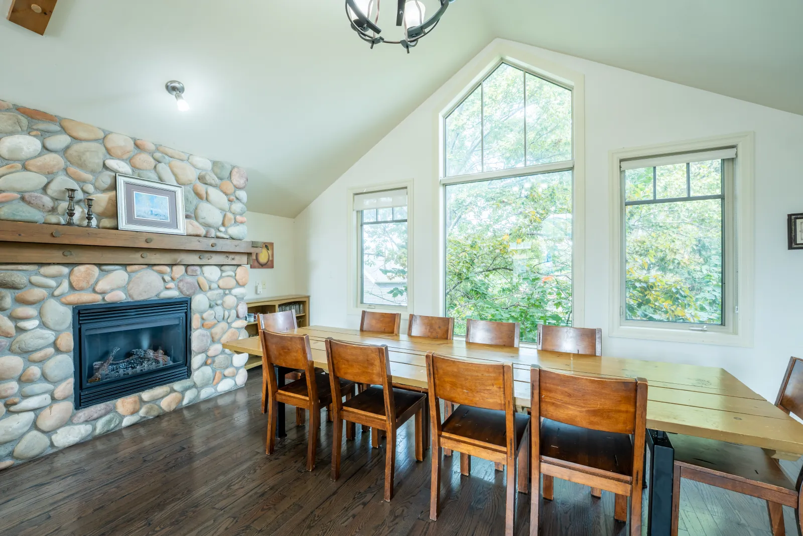 The Prima gallery: dining table beside the stone fireplace