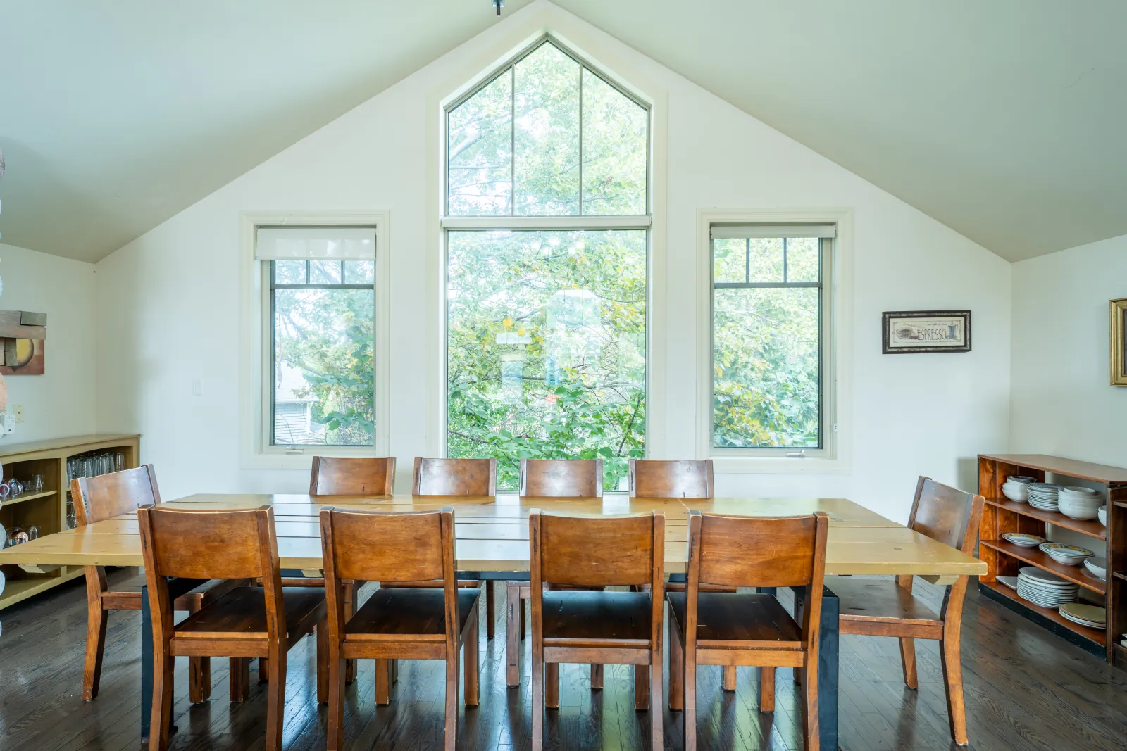 The Prima gallery: dining table beneath the tall peaked windows
