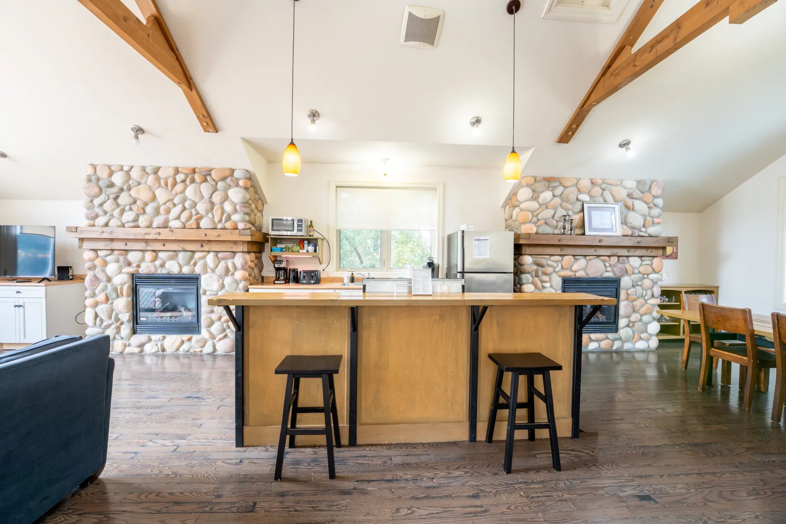 The Prima gallery: kitchen island between two stone fireplaces