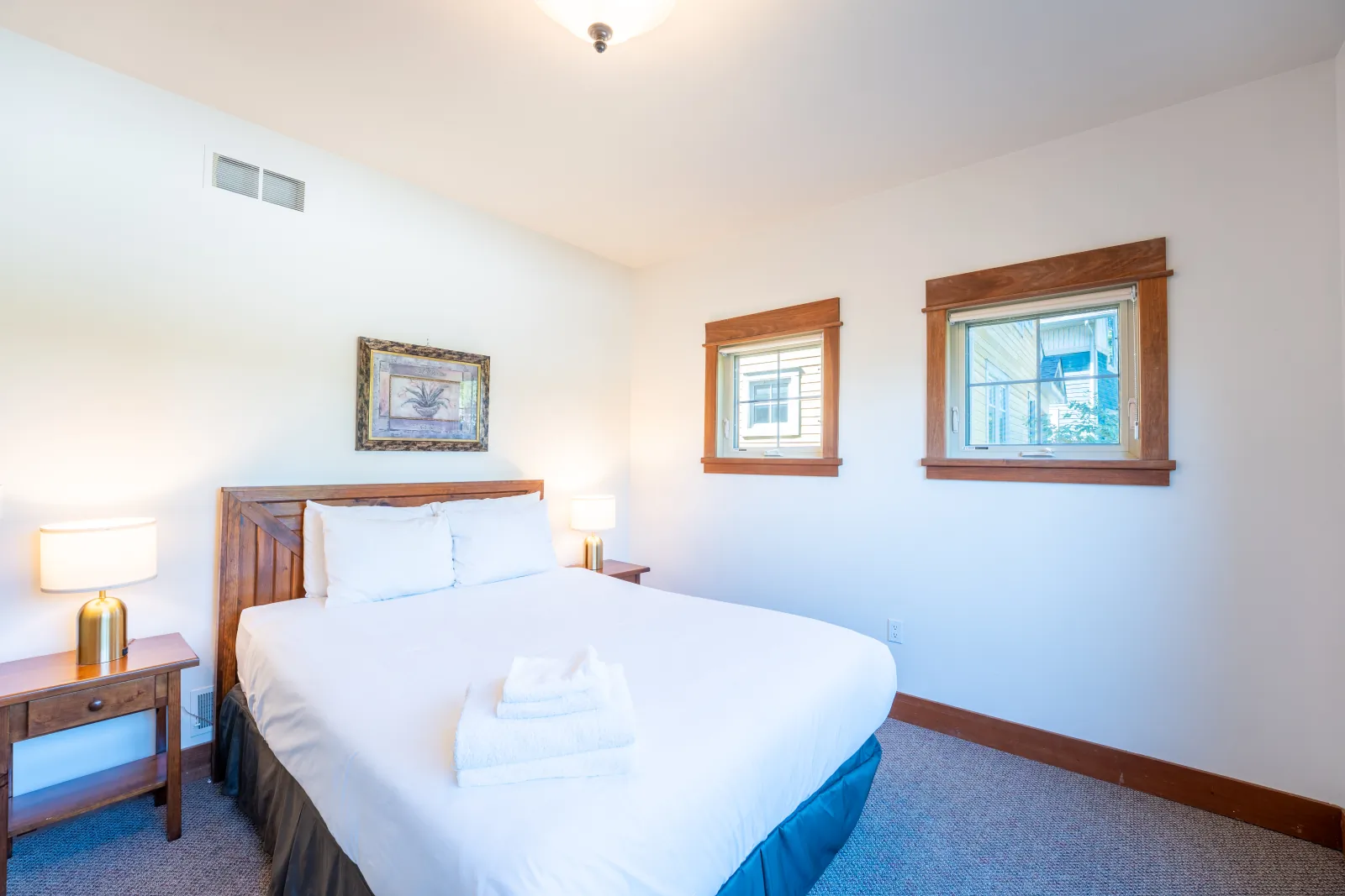 The Vega gallery: king bedroom with white bedding and three windows
