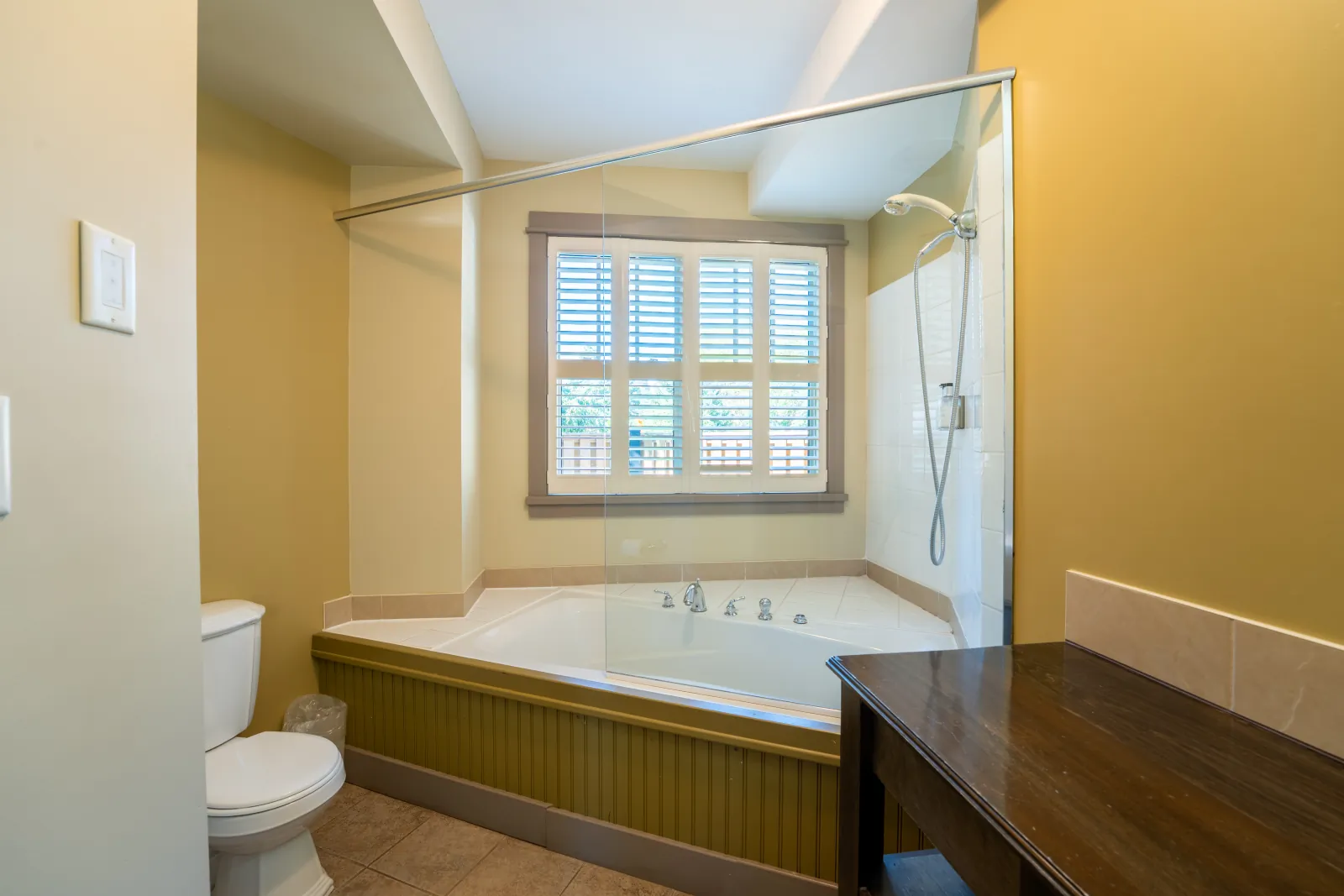 The Vista gallery: corner tub under a shuttered window