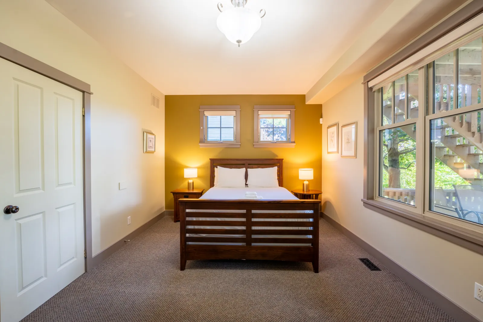 The Vista gallery: queen bed between two lamps with corner windows