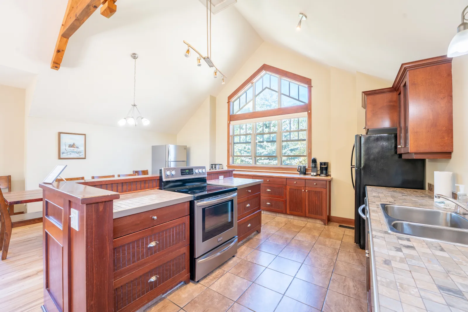 The Vista gallery: kitchen island, range and sink under the vaulted ceiling